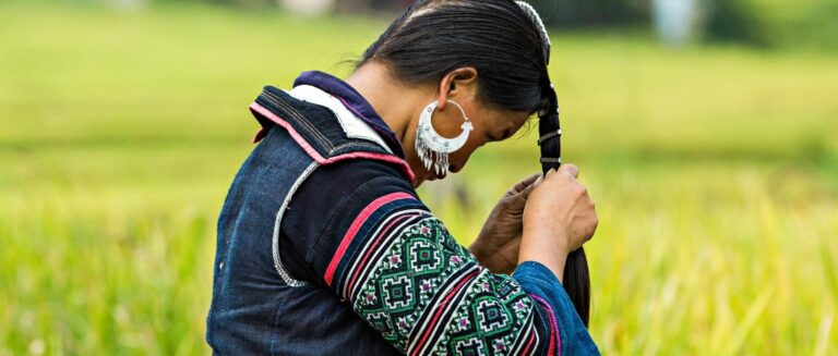 A Hmong lady fixing her hair in the mountainous area of Sapa